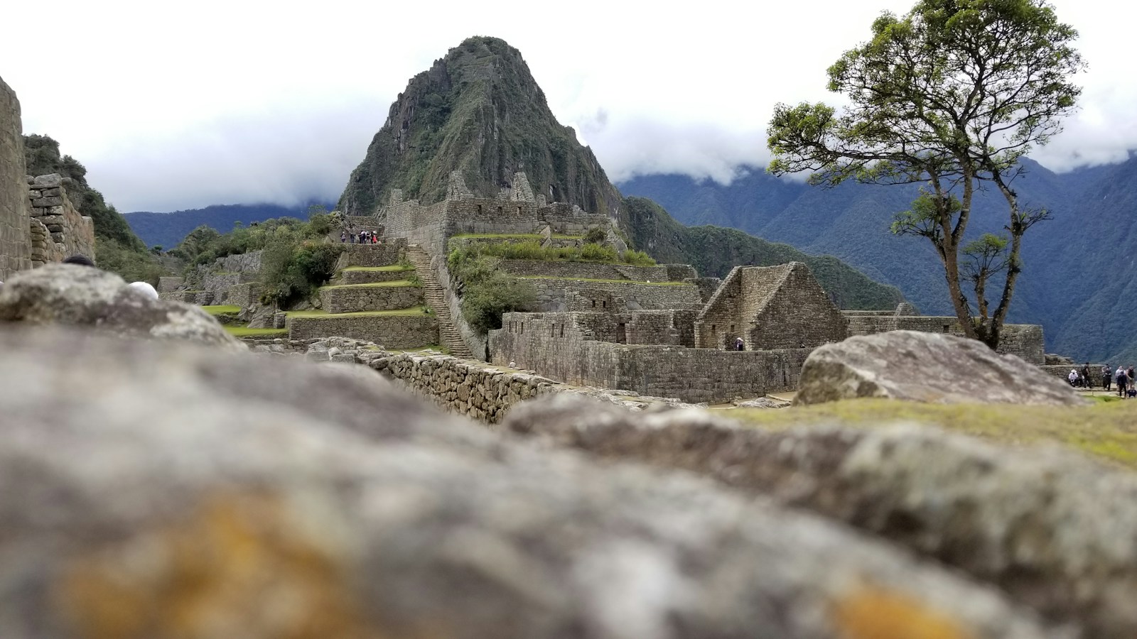 Inca stone walls at Machu Picchu beneath Huayna Picchu