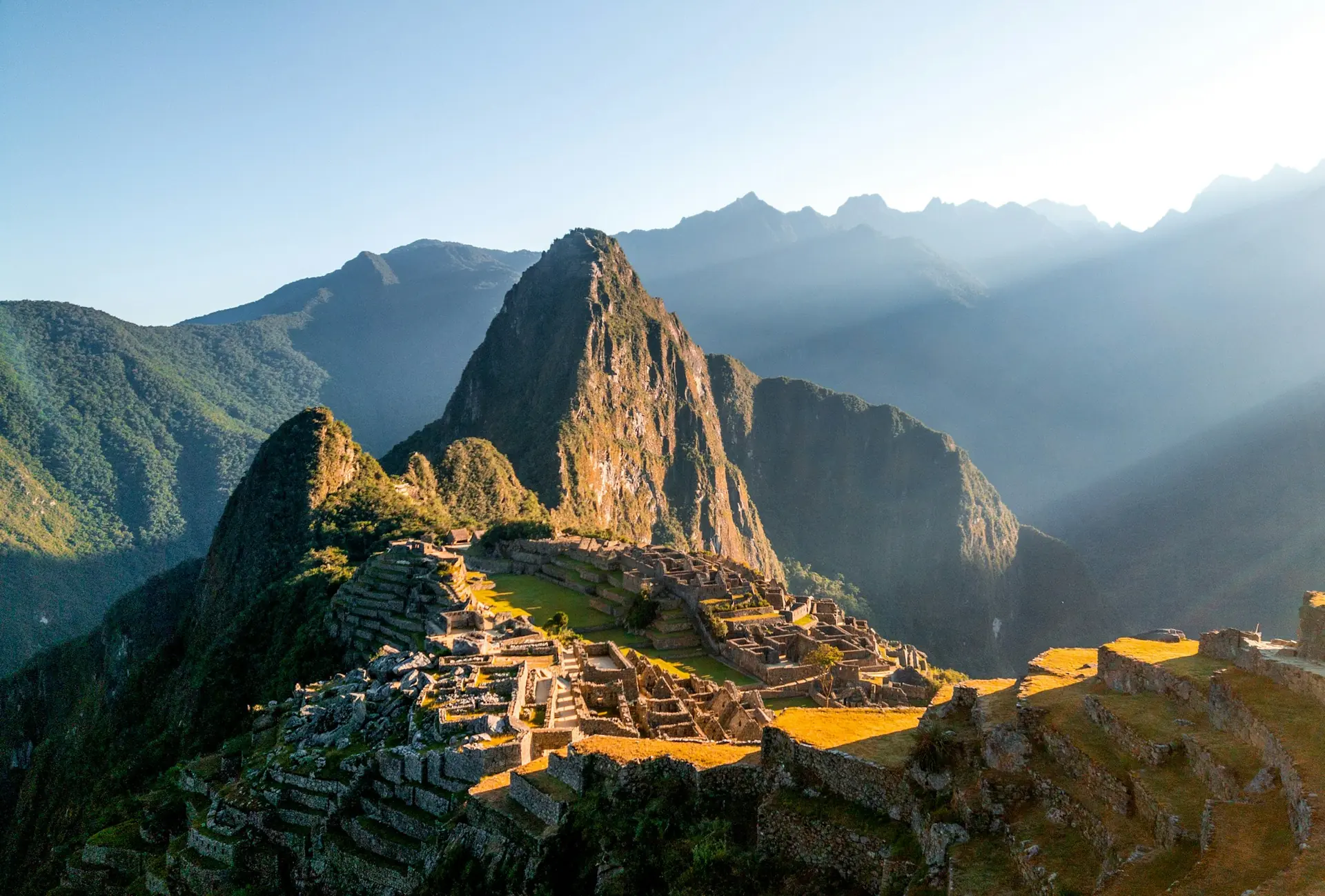 Morning sunlight on Machu Picchu’s stone terraces and Huayna Picchu
